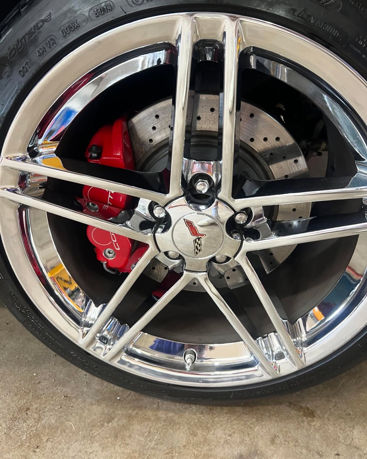C6 Corvette chrome wheel and red caliper after cleaning