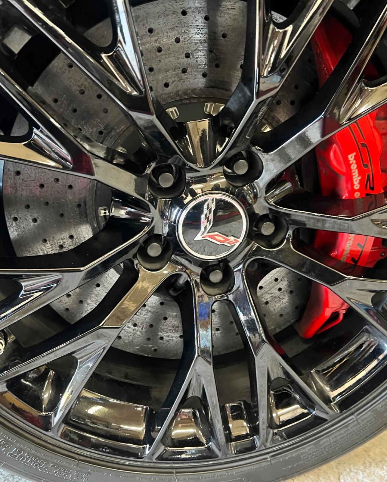 C8 Corvette wheel and red brake caliper after cleaning