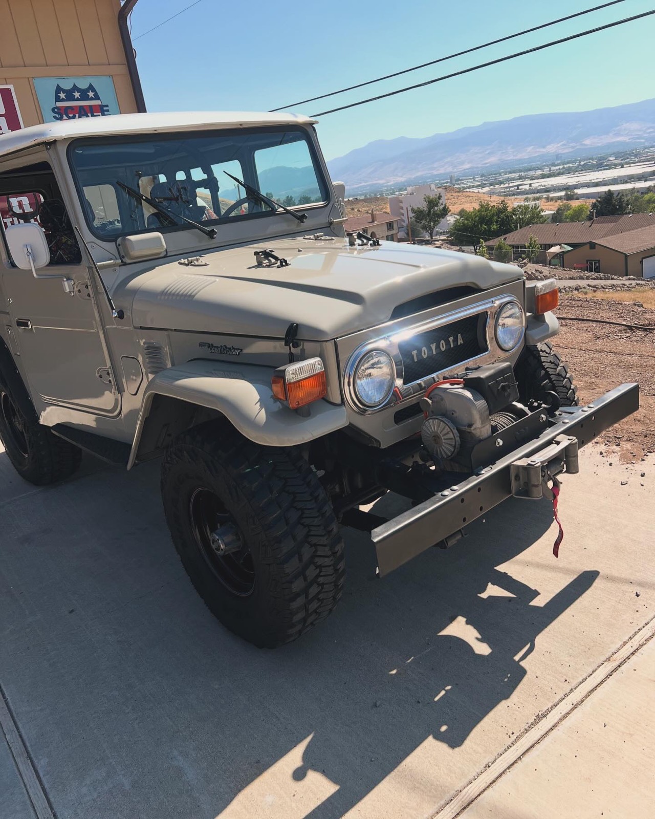 Classic Toyota Land Cruiser FJ40 detailed, with the Sierra foothills behind it