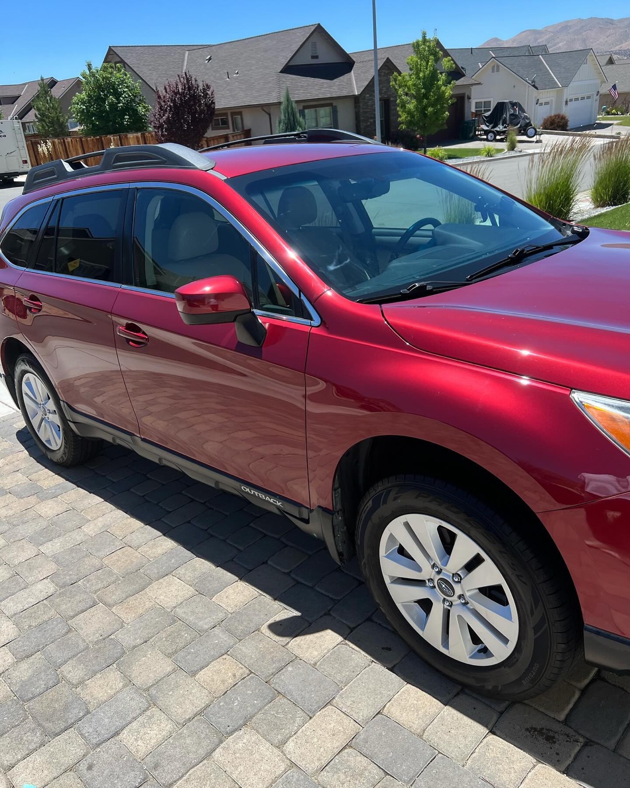 Red Subaru Outback side after a full detail
